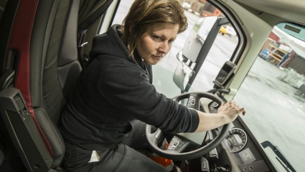 en kvinnlig lastbilschaufför vid ratten